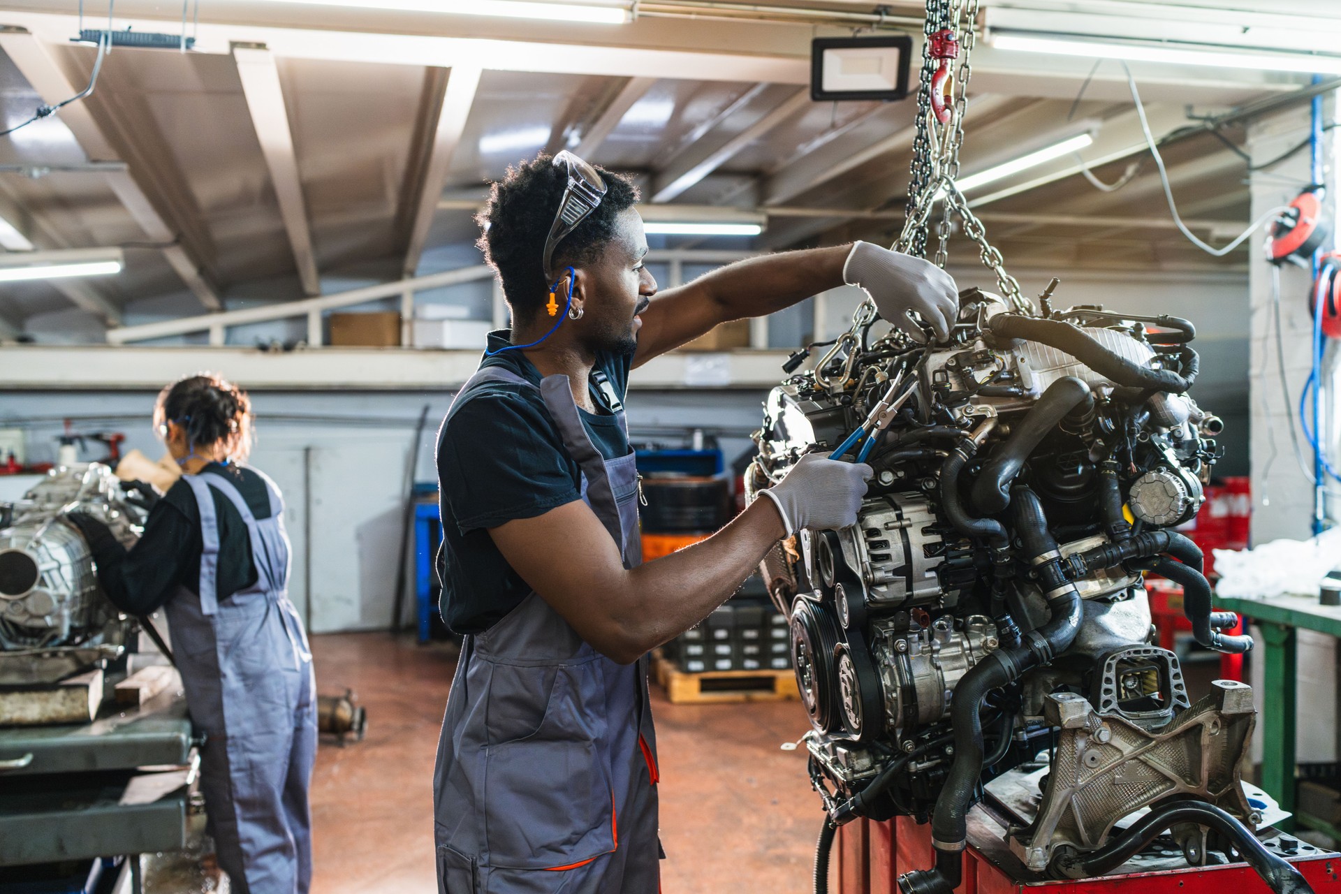 Mechanics repairing car engine in auto repair shop